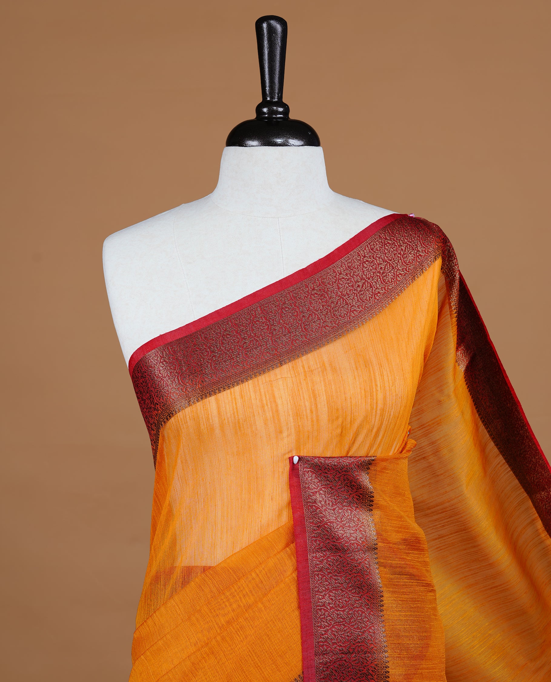 Mustard colour Semi linen saree featuring Elegant plain body, complemented by contrast Maroon colour With Antique zari border, paired with matching blouse piece.