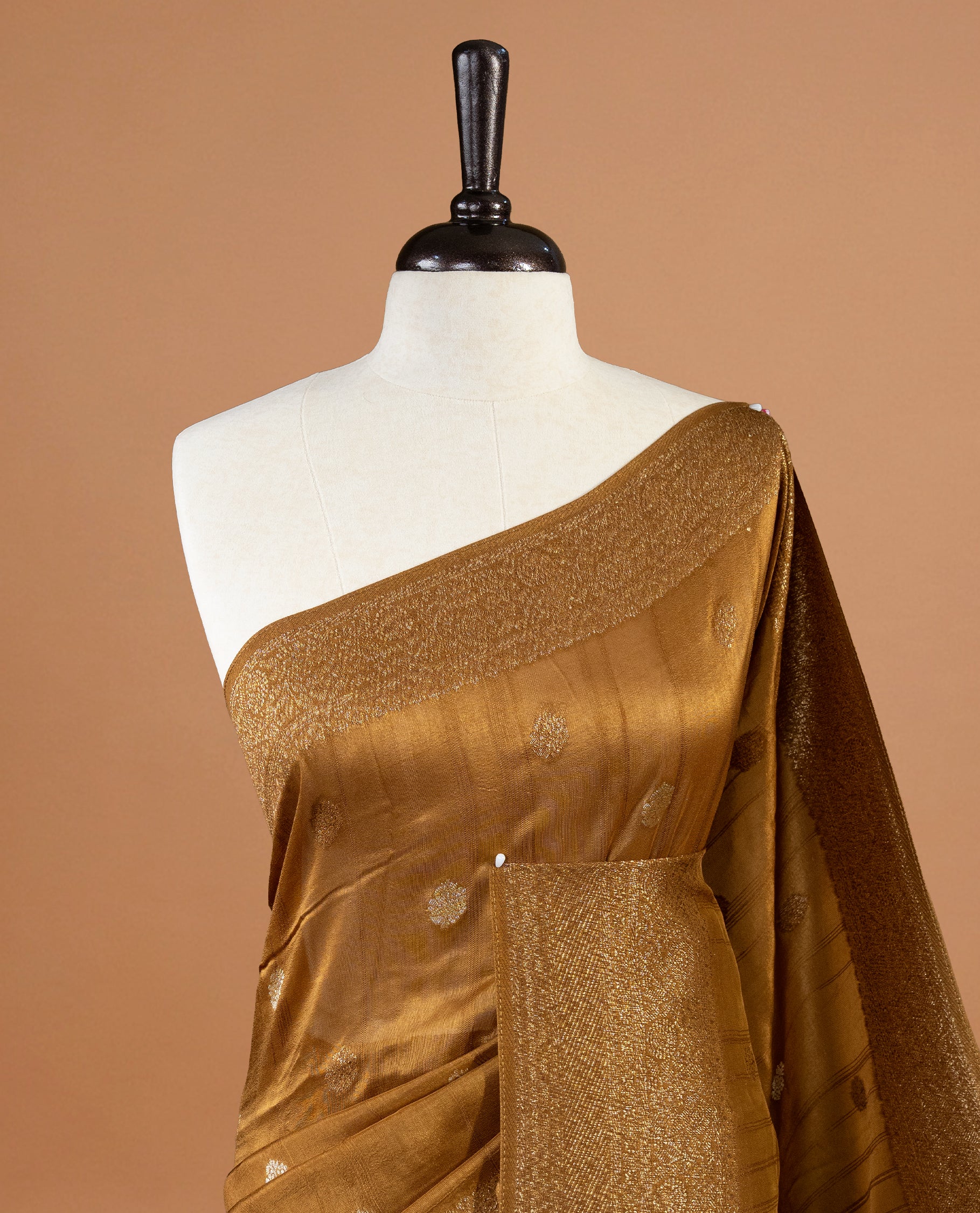 Burnt Mustard colour Semi banaras tussar georgette Saree featuring Antique zari motifs on body, enhanced with antique zari border, paired with a matching blouse piece.