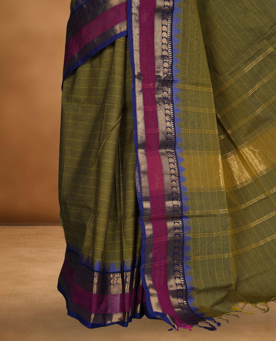 Olive colour chettinad cotton saree featuring stripes on body highlighting contrast magenta and blue with gold zari border, pallu and paired with matching blouse piece.