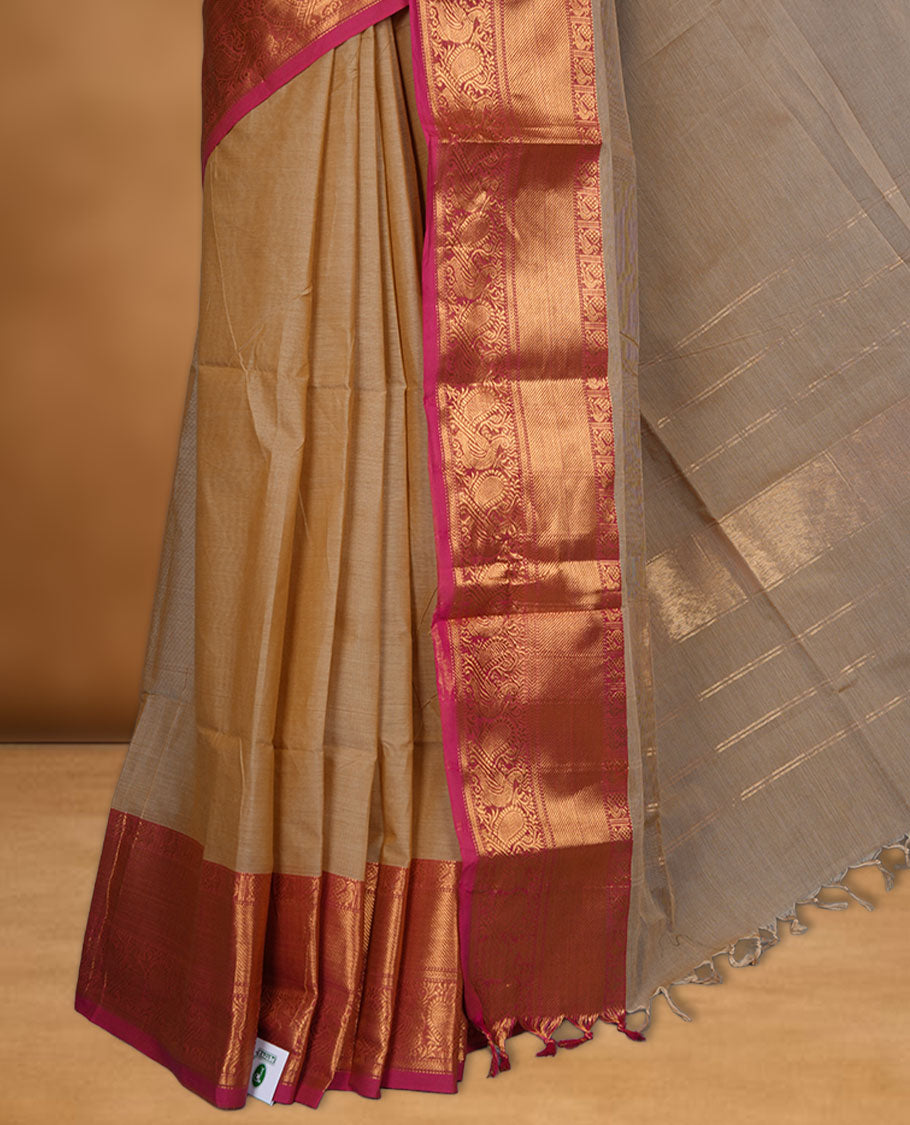 Beige colour chettinad cotton saree featuring Elegant plain body, contrast Magenta colour border with gold zari border, pallu and paired with matching blouse.