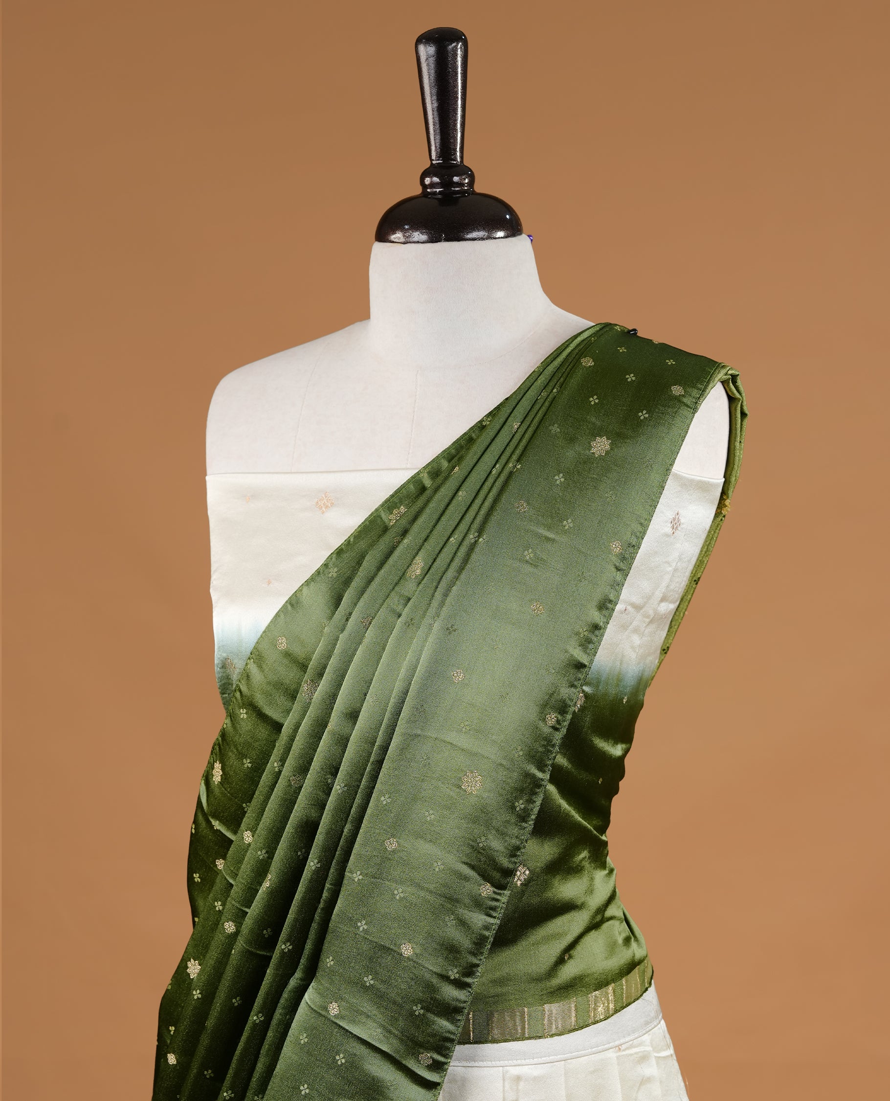 Off White colour half saree material featuring delicate zari buttas on the blouse and skirt, paired with a contrast Green zari border and matching small zari motifs dupatta