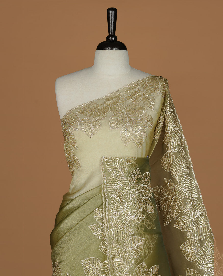 Green & gold double shade organza saree featuring thread & cut beats, sequins leaf pattern on body, highlighting scalp border, paired with matching blouse piece.