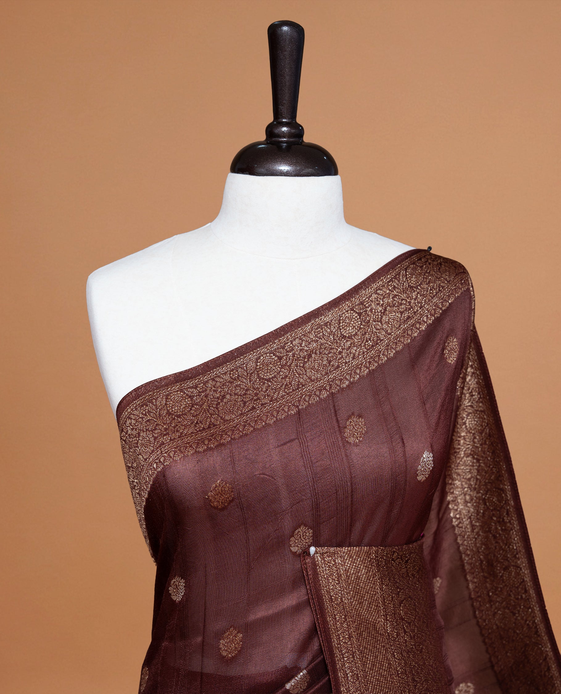 Chocolate brown colour Semi banaras tussar georgette Saree featuring Antique zari motifs on body, enhanced with antique zari border, paired with a matching blouse piece.