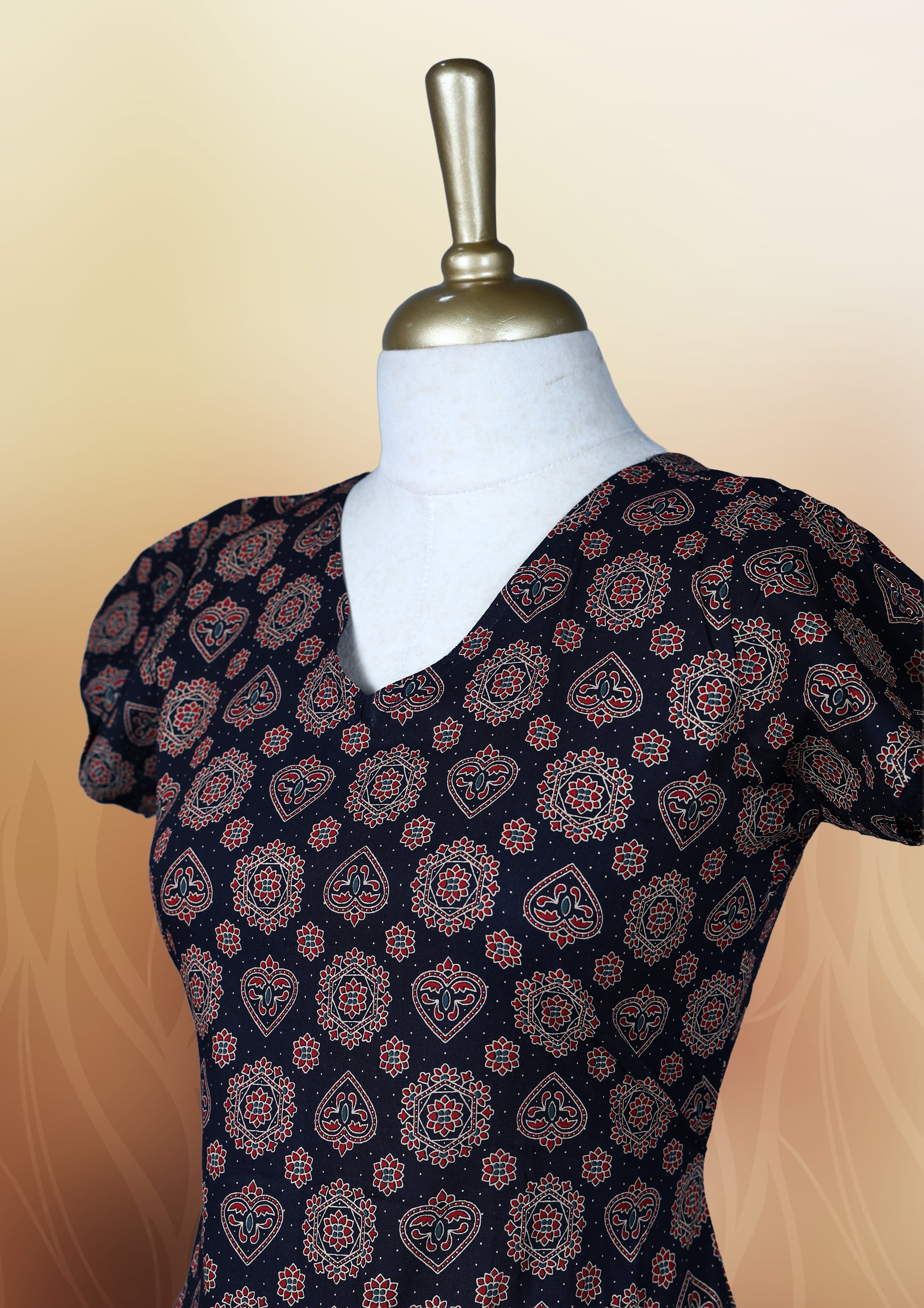 Black colour nightwear adorned with soft maroon floral prints, featuring a V neckline, short sleeves, and a flared ruffle hem, A stylish and comfortable choice for daily wear, brunches, or casual outings.