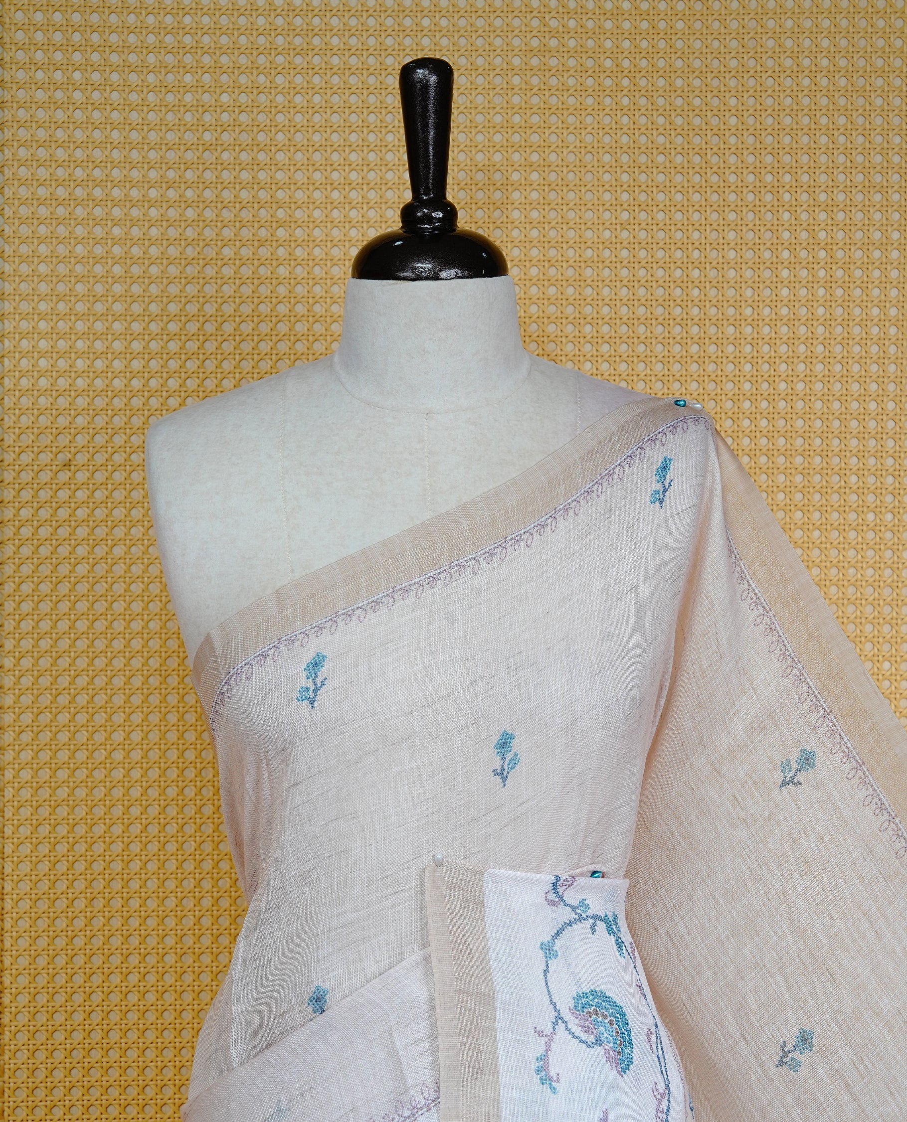 Beige colour semi linen saree featuring floral print on body, complemented by contrast Light gold colour with Design print border, comes with matching blouse piece.