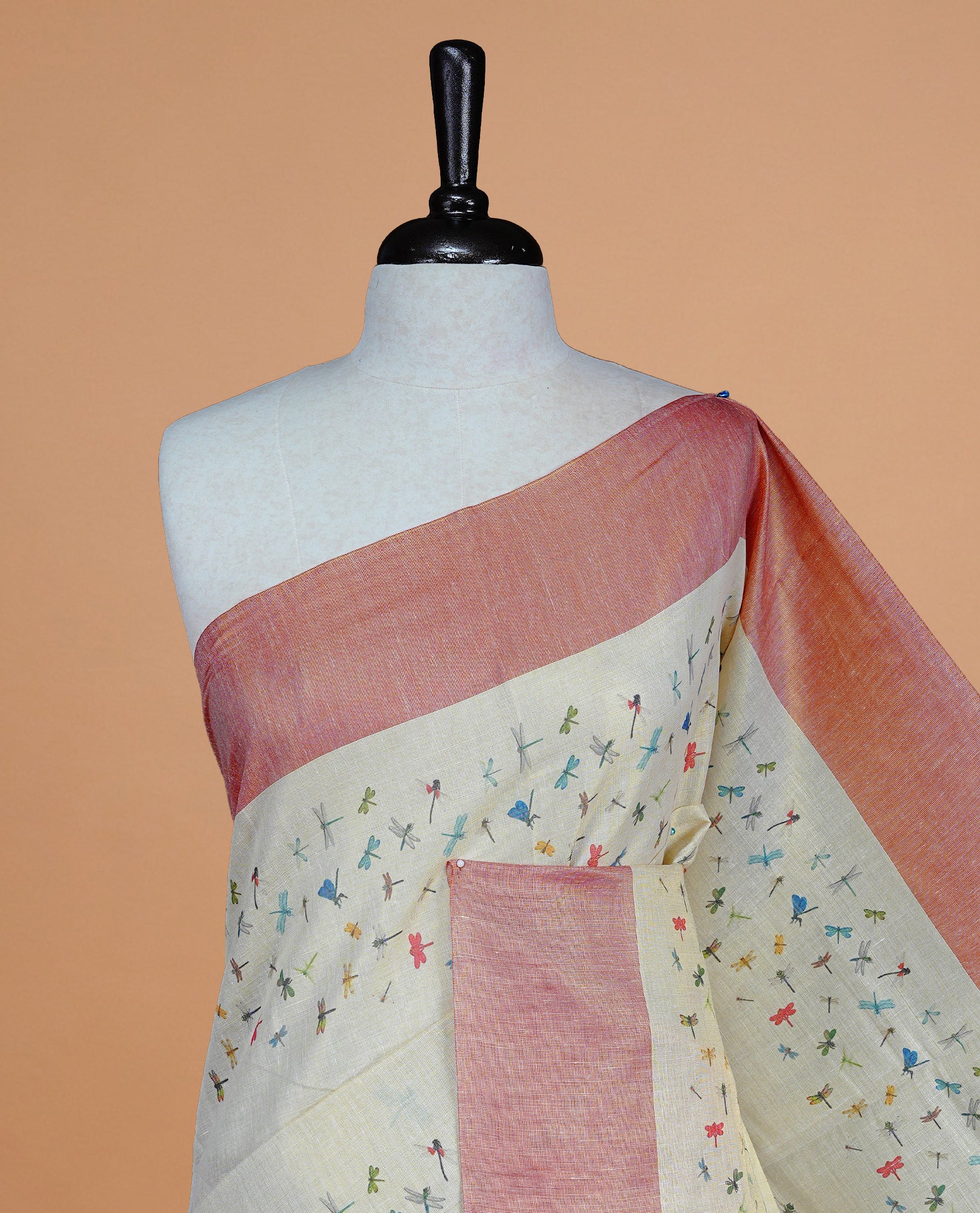 Cream Colour Kerala Saree Featuring Plain Body ,Complemented By A Red Zari With Dragonfly Printed Border ,Enhance By A Red With Gold Zari Pallu ,Paired With A Matching Blouse Piece.