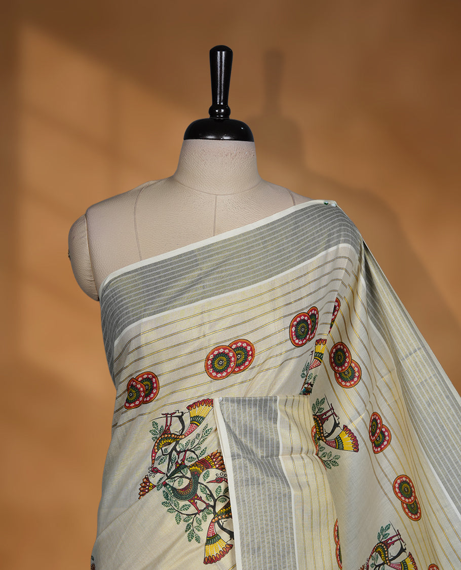 Light gold colour Tissue Kerala saree featuring a Plain body, an intricately woven gold and blue traditional pallu and border with chakra and peacok pattern paired with a matching blouse.