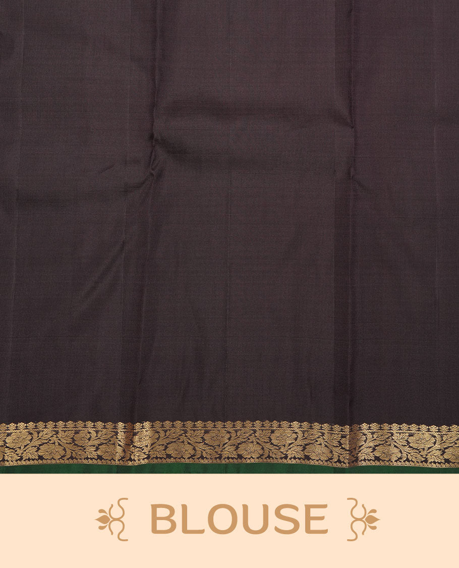 Deep coffee brown colour pure traditional Kancheepuram silk saree adorned with elegant zari tree motifs across the body, complemented by a rich zari woven border with a subtle green edge, paired with a matching blouse piece.