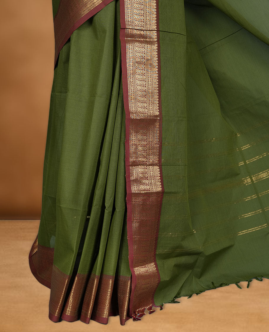 Olive green colour chettinad cotton saree featuring Elegant plain body, contrast Brick red colour border with gold zari border, pallu and paired with matching blouse.