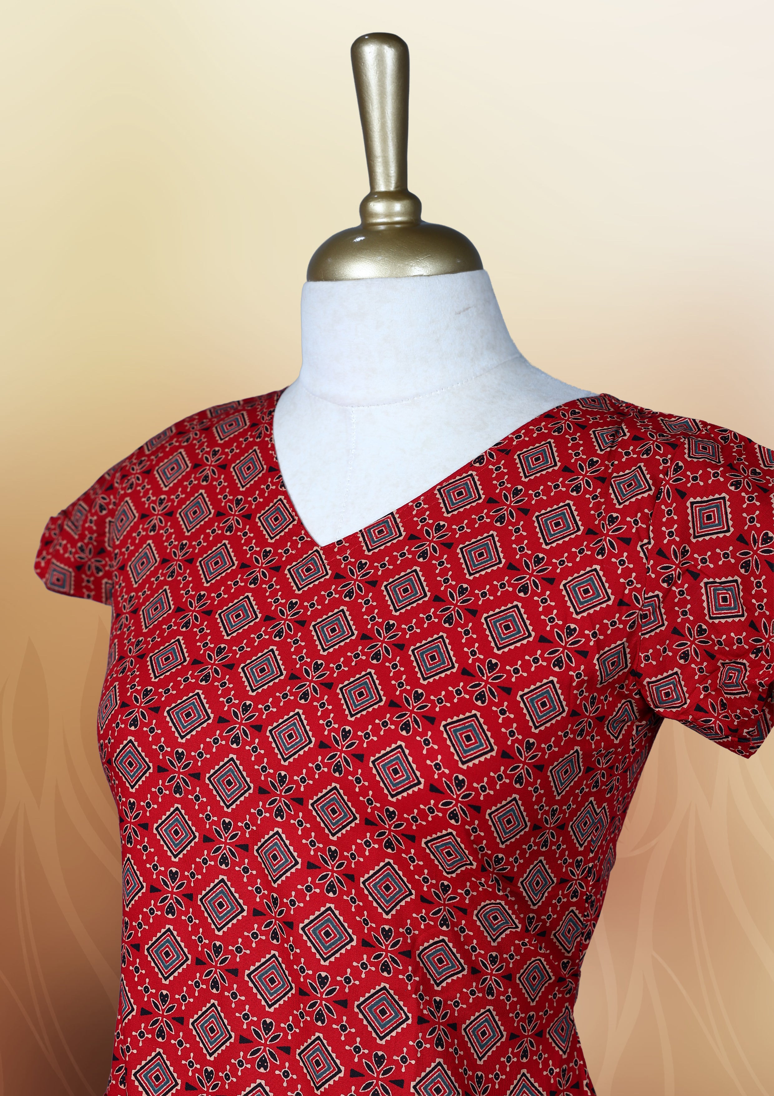 Red colour nightwear with a flattering V neck, short sleeves, and a geometric print & Features a fitted silhouette with a flared hem, Perfect for casual outings or festive occasions.