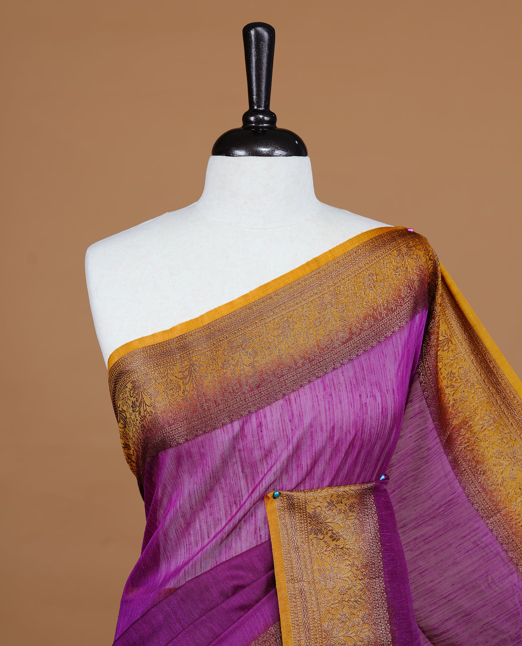 Purple colour Semi linen saree featuring Elegant plain body, complemented by contrast Mustard colour With Antique zari border, paired with matching blouse piece.