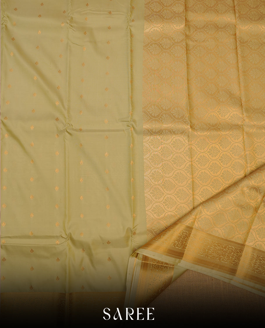 Firgreen colour shirt and dhoti with gold colour border, paired with matching colour silk saree featuring gold zari buttas and traditional border paired with matching blouse piece.