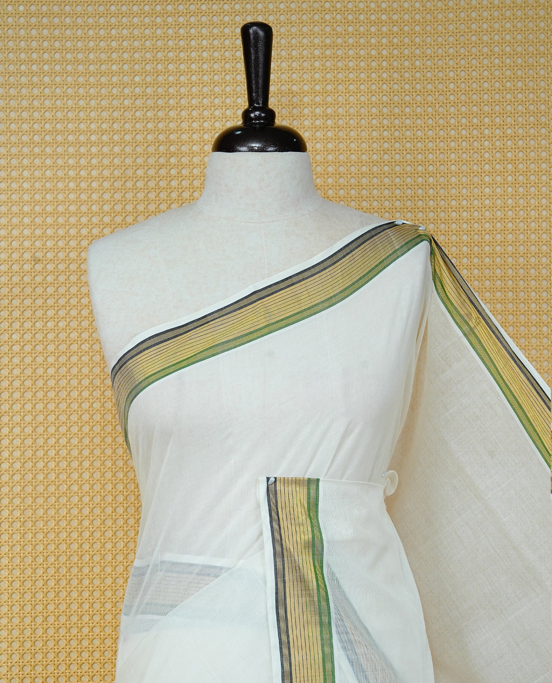 Cream colour Cotton kerala saree featuring Classy Plain body, complemented by Gold with Green & Black zari border & Pallu, paired with matching blouse piece.