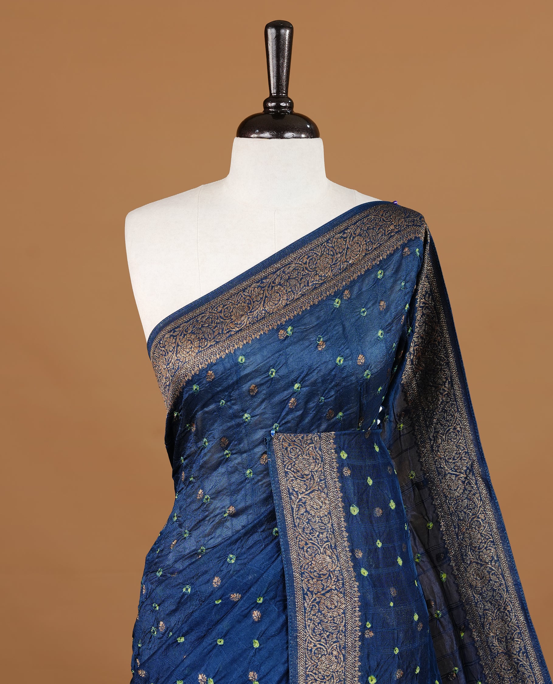 Persain Blue colour Banarasi Bandhani silk saree featuring intricate antique zari circle Buttas across the body, complemented by an elegant antique zari border. Comes paired with a matching blouse piece