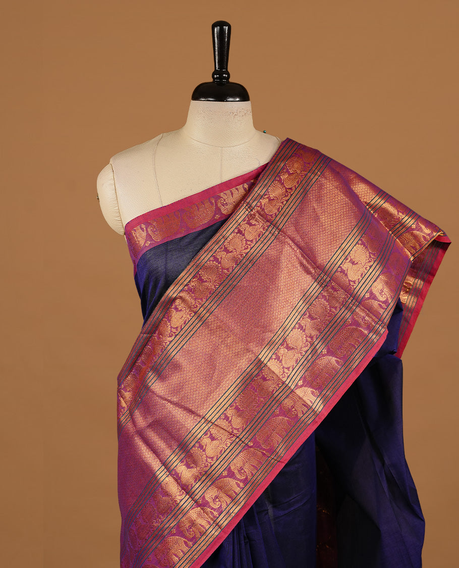 Navy blue colour chettinad cotton saree featuring Elegant plain body, complemented by magenta colour with traditional border, paired with matching blouse piece.
