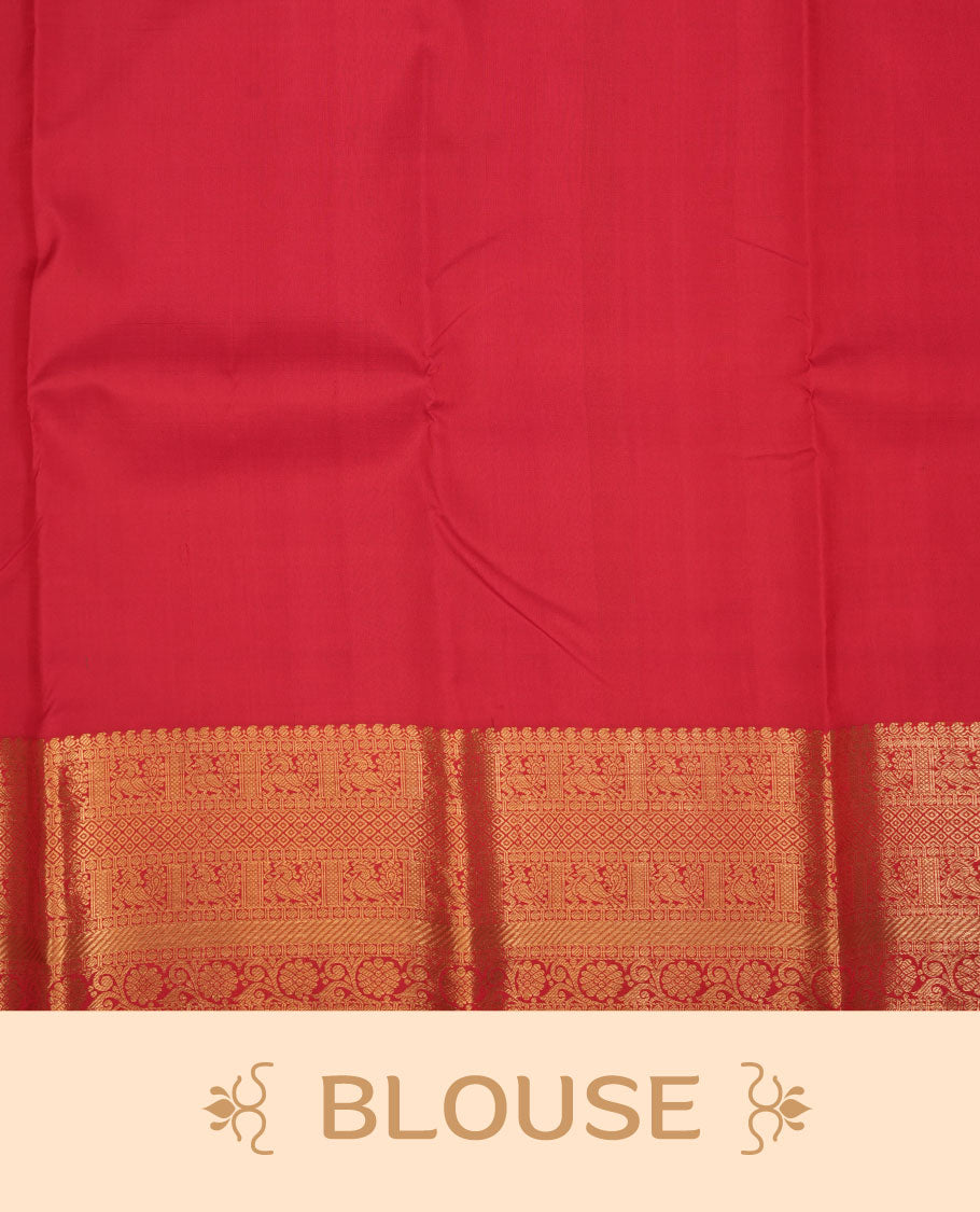 Vibrant red colour pure traditional Kancheepuram silk saree adorned with an elegant zari elephant motif on the body, complemented by a rich gold zari woven border featuring intricate traditional designs, paired with a matching blouse piece.