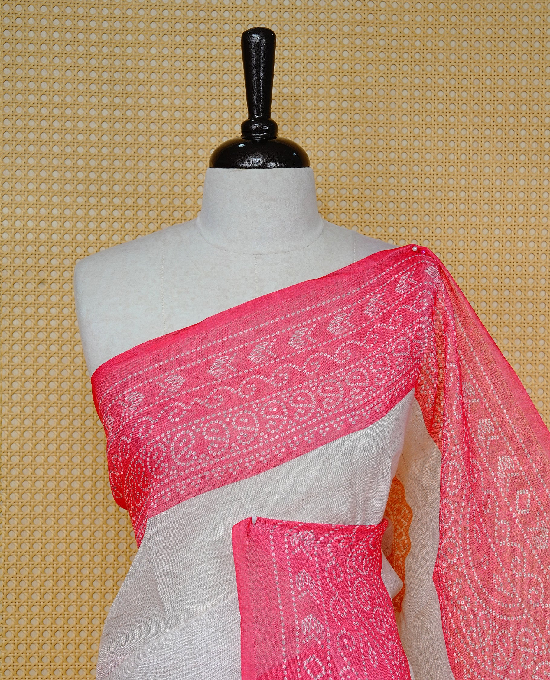 Cream colour semi linen saree featuring Mustard Ajrakh pattern print on body, complemented by contrast Light red colour with same pattern print border, comes with matching blouse piece.