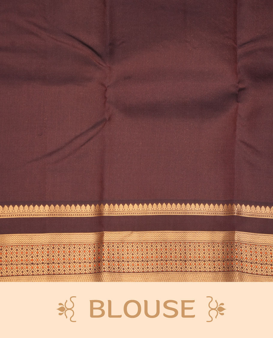 Burnt orange colour vasundhara silk sareee featuring zari buttas on body, complemented by contrast deep maroon colour with zari border, paired with matching blouse piece.