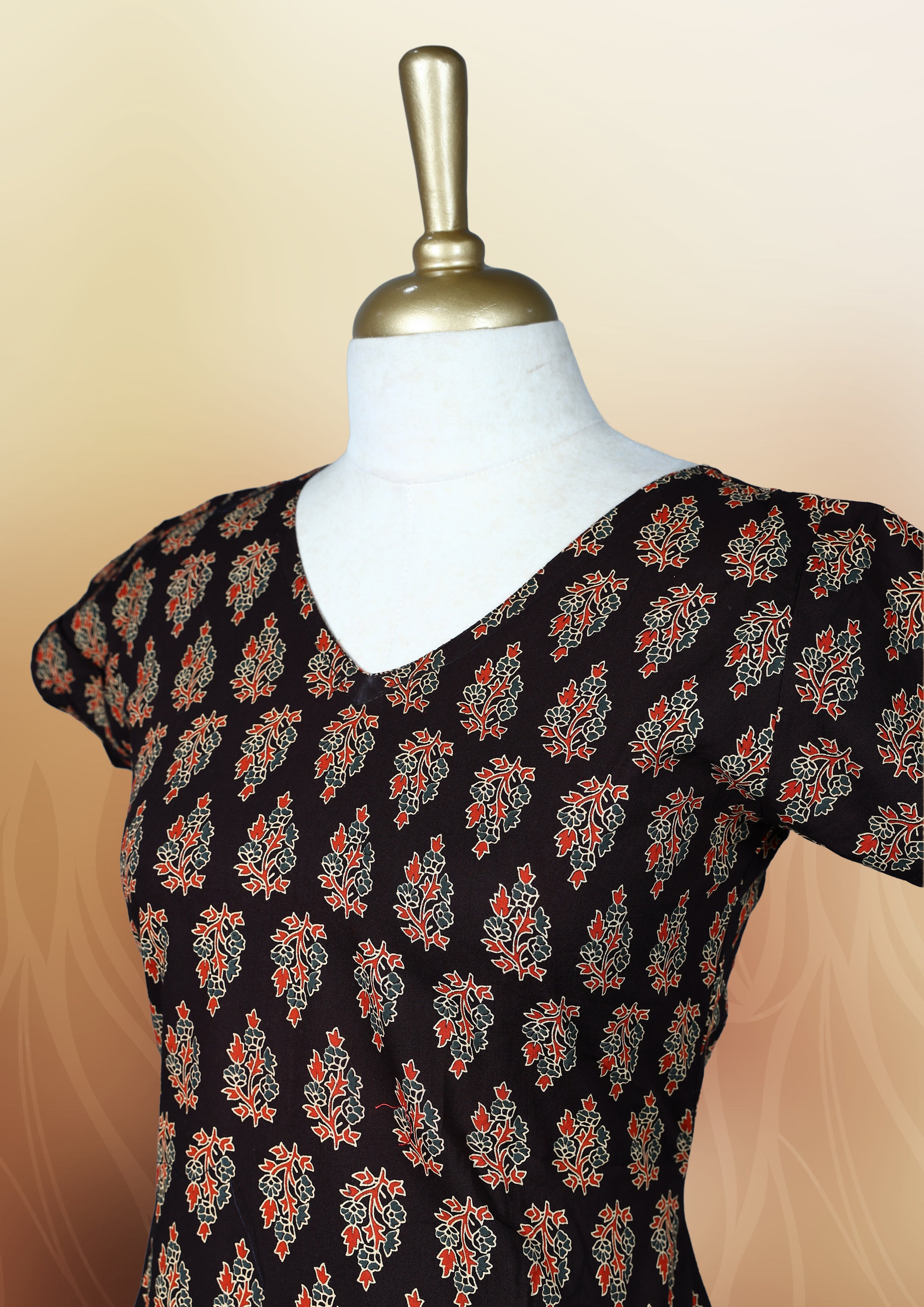 Brownish black colour nightwear with traditional block print motifs in red and beige, Features a V neck, short sleeves, and a stylish tiered flared hem, Perfect for festive events, casual wear, or cultural gatherings.