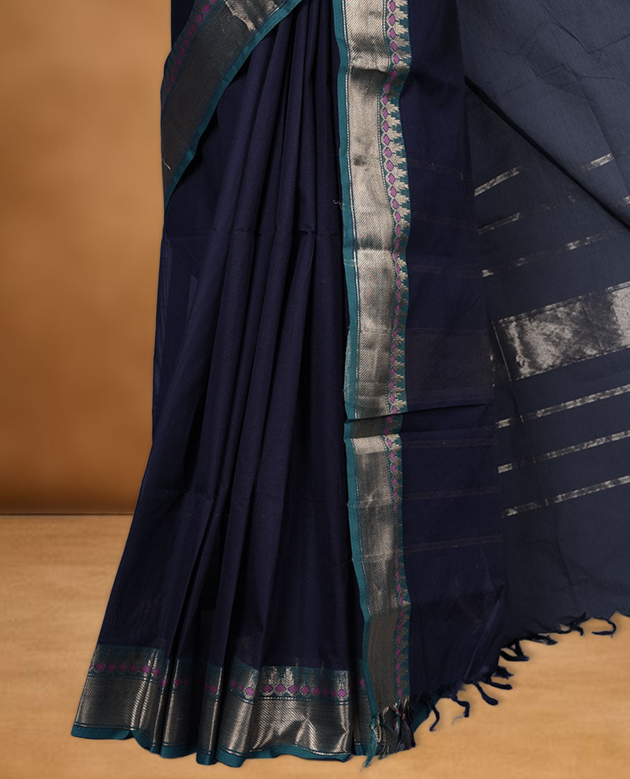 Dark Blue colour chettinad cotton saree featuring Elegant plain body, contrast green colour border with gold zari border, pallu and paired with matching blouse.