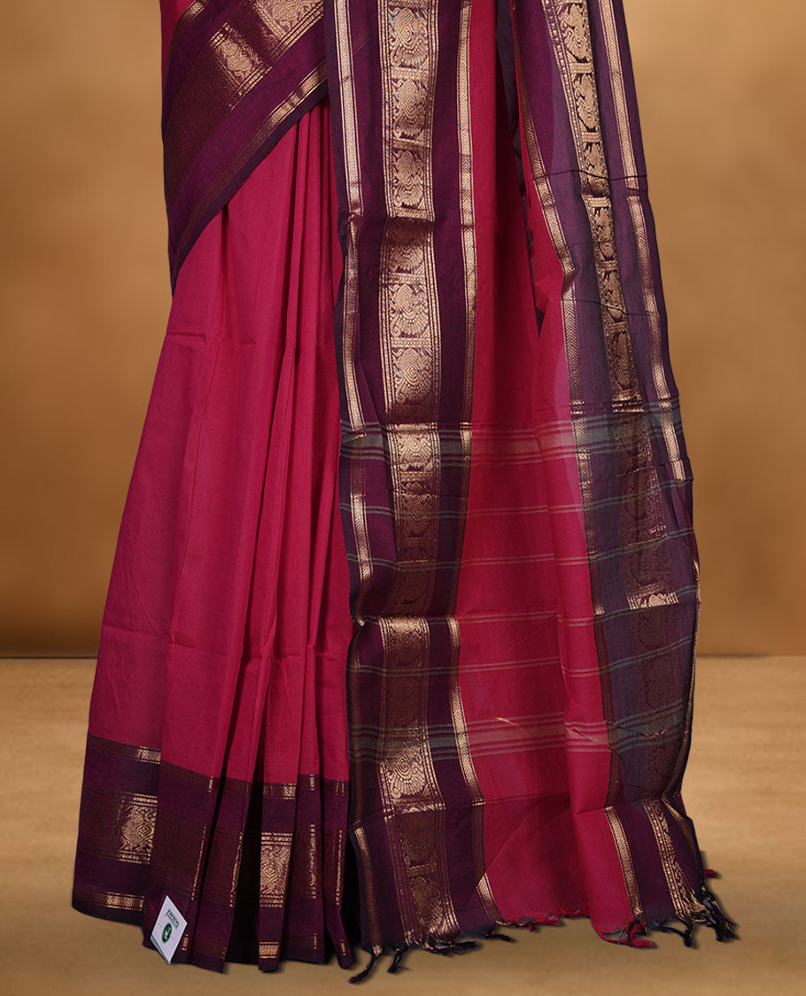 Rani pink colour chettinad cotton saree featuring plain body, contrast burgundy colour with traditional gold zari border paired with matching blouse.