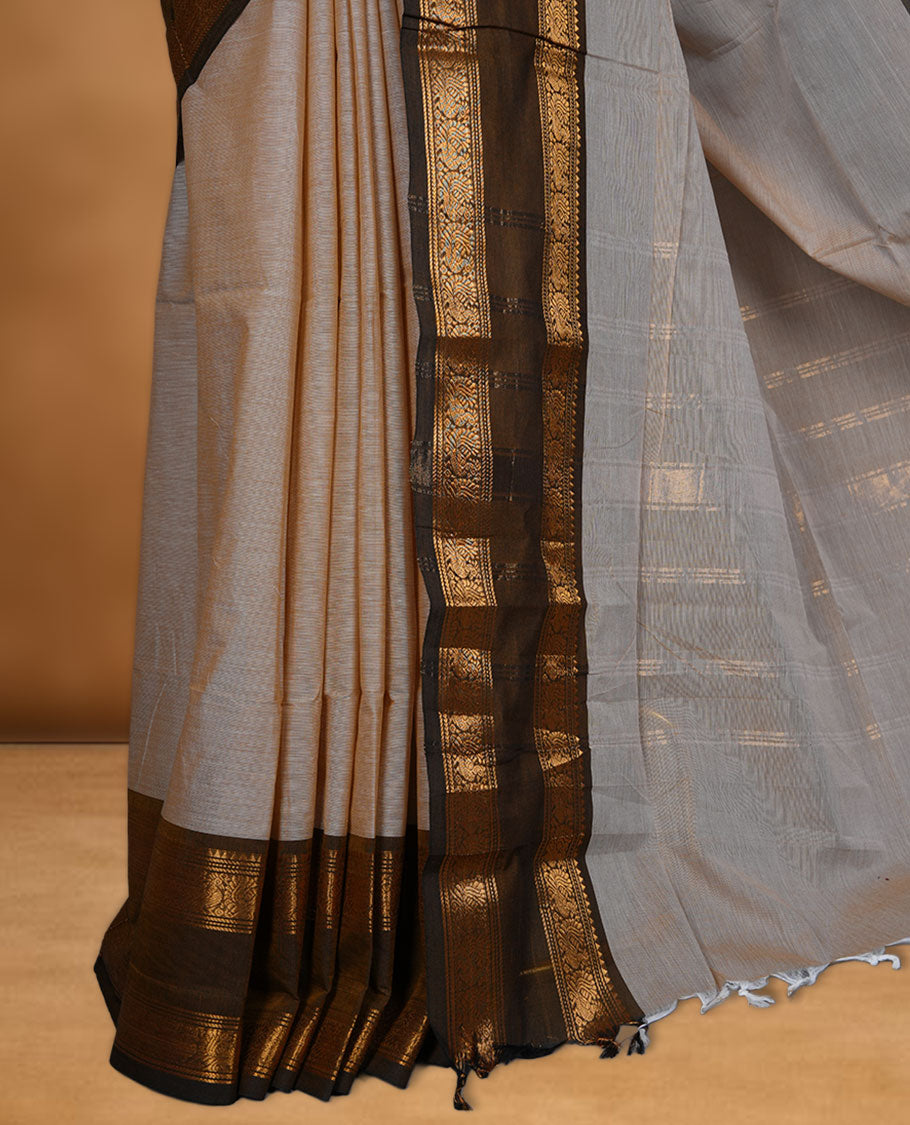 Beige colour chettinad cotton saree featuring Elegant body, contrast Olive colour border with gold zari border, pallu and paired with matching blouse.