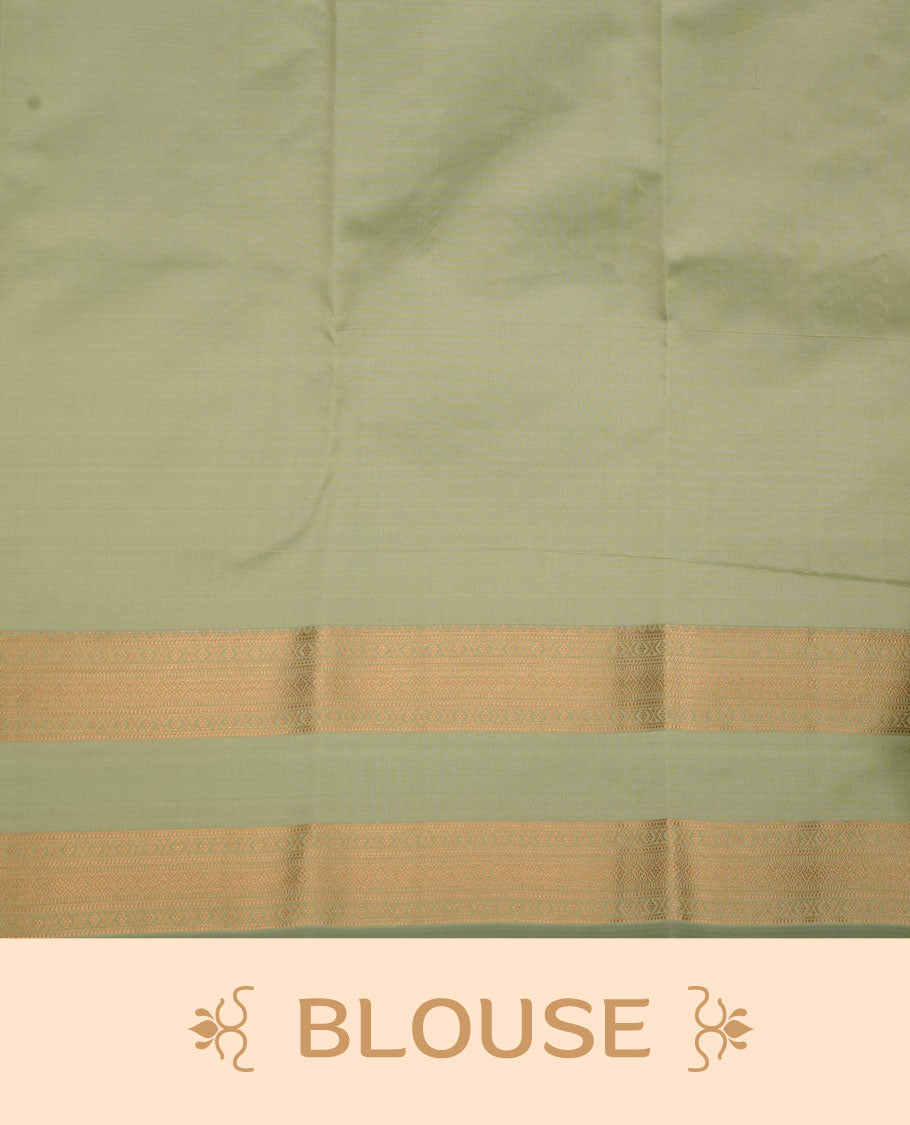 Dark mango yellow colour Vasundhara silk saree featuring elegant gold zari buttas across the body, complemented by a contrast pista green zari border, and paired with a matching blouse piece.