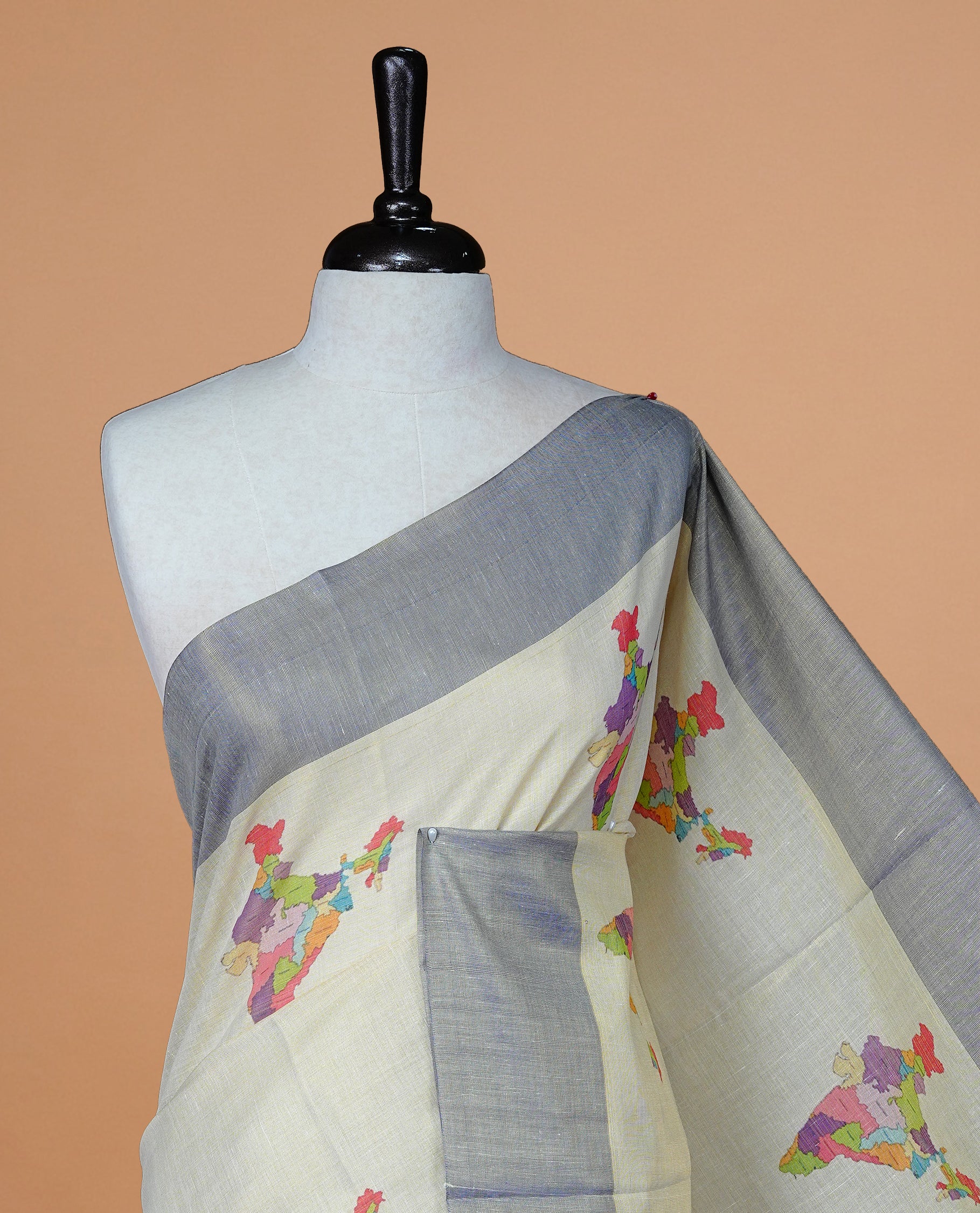 Cream Colour Kerala Saree Featuring Plain Body ,Complemented By A Blue Zari With Indian Map Border ,Enhance By A Gold Zari & Blue Pallu ,Paired With A Matching Blouse Piece.
