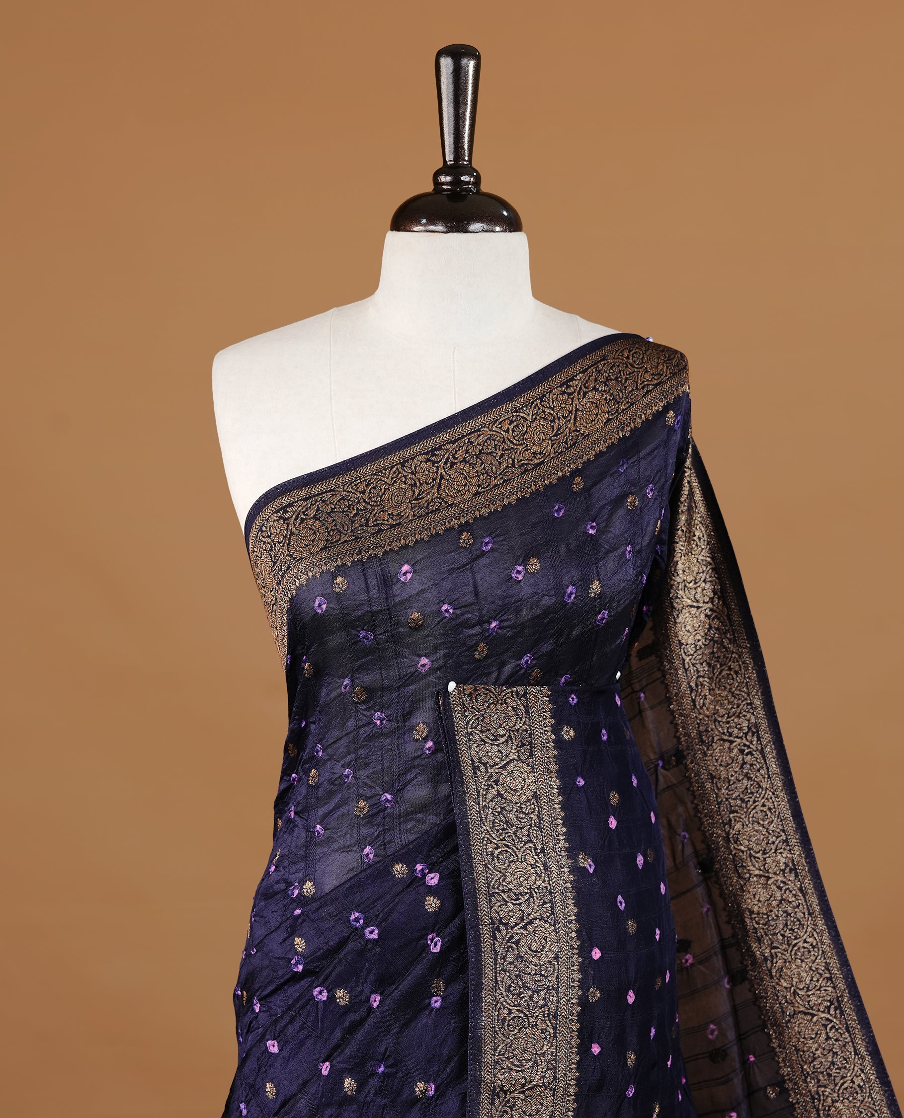 Dark purple colour Banarasi Bandhani silk saree featuring intricate antique zari circle Buttas across the body, complemented by an elegant antique zari border. Comes paired with a matching blouse piece