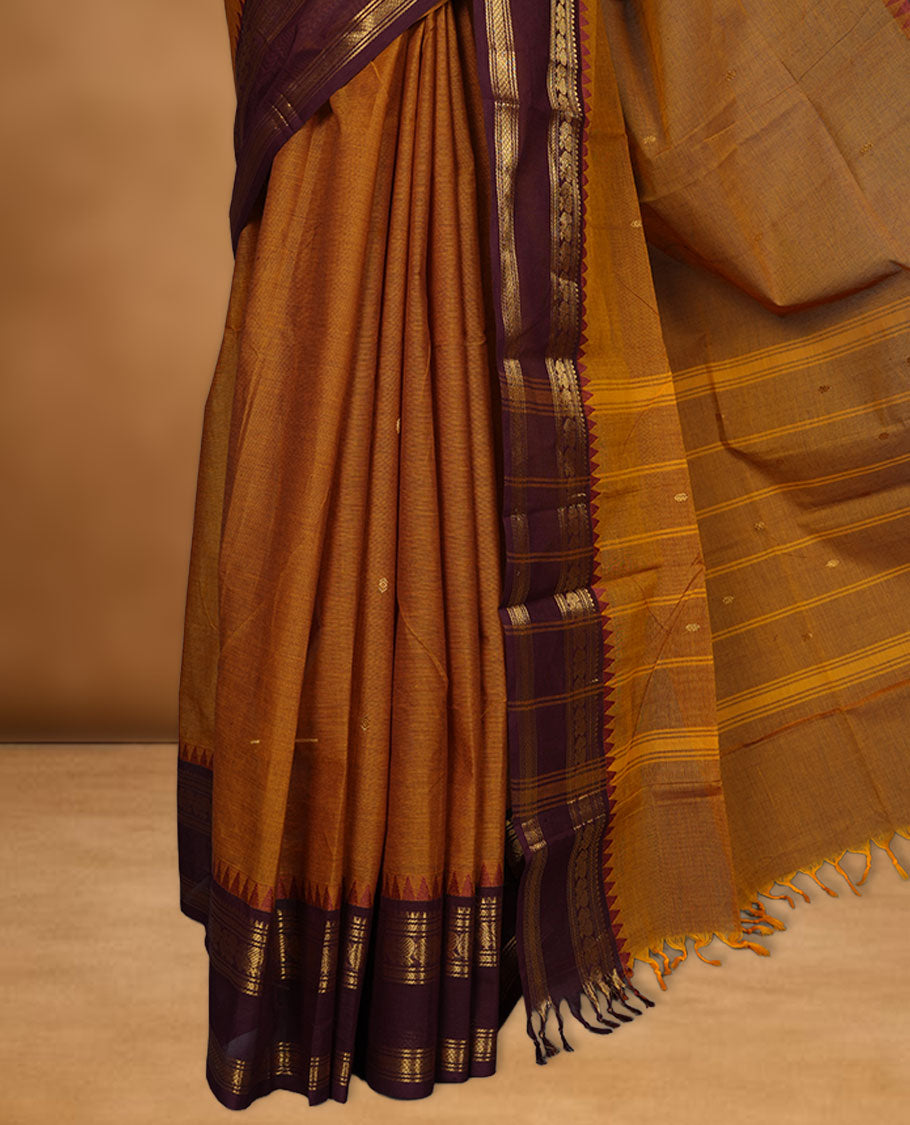 Mustard colour chettinad cotton saree featuring Purple colour motifs on body, contrast maroon colour border with gold zari temple border, pallu and paired with matching blouse