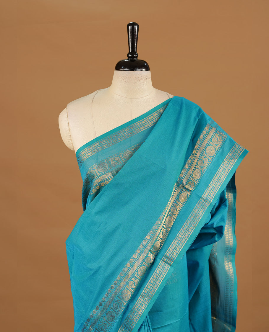 Aqua colour chettinad cotton saree featuring elegant plain body, complemented by self colour with zari border, paired with matching blouse piece.