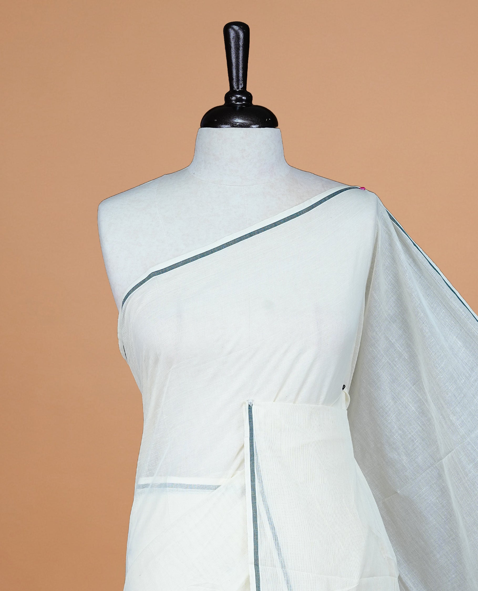 Cream Colour Kerala Saree Featuring A Plain Body, Enhanced By A Minimalistic Black Border, Paired With A Matching Blouse Piece.