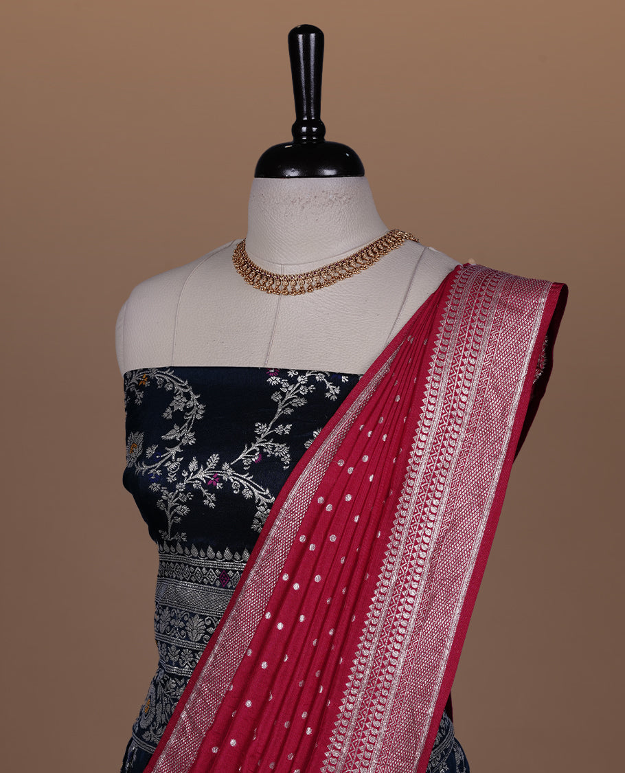 Teal colour semi banaras semi stitched dhavani set featuring gold zari floral kodi motifs and traditional border, unstitched matching blouse piece and contrast Red colour Duptta with silver zari border border.