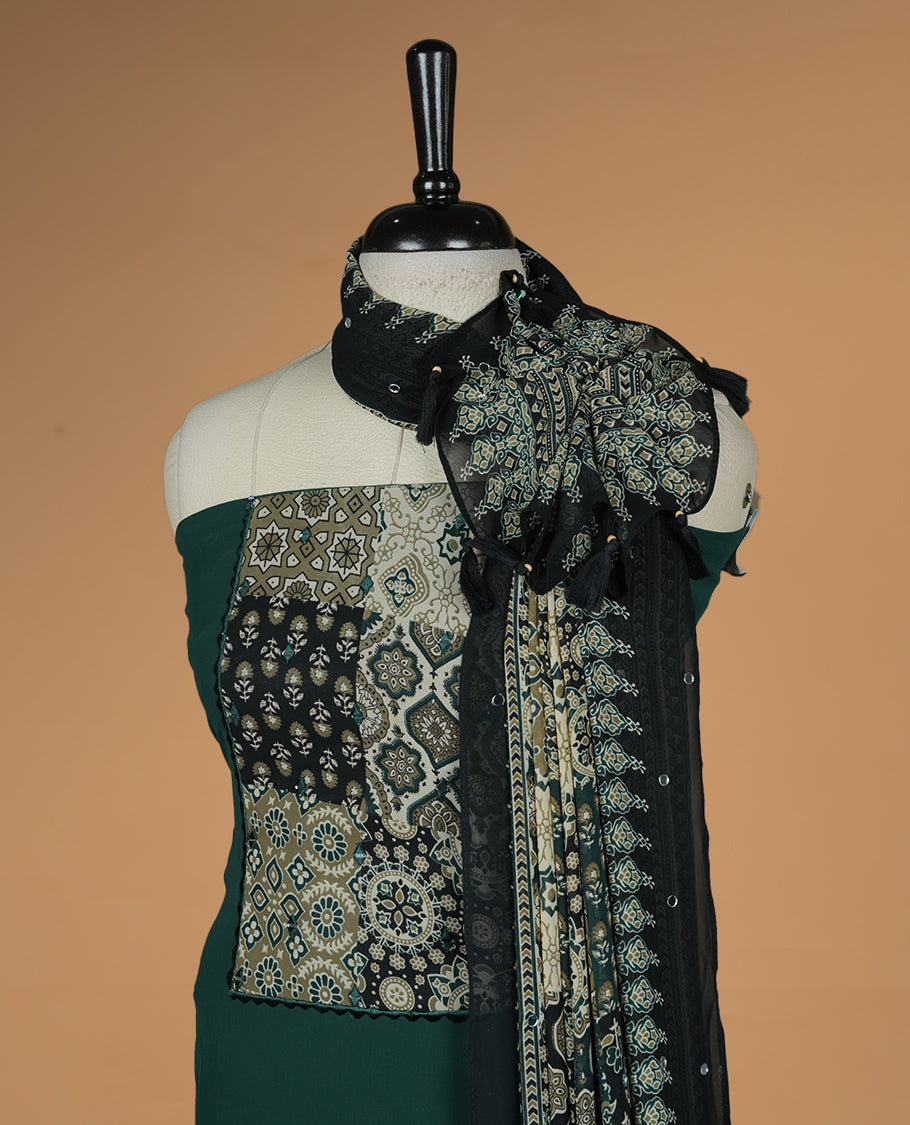Green colour georgette salwar suit collection featuring plain body enhanced with elegant black bunch kalamkari print on neck yoke, detailed with subtle mirror work , paired with kalamkari printed dupatta with mirror work with santon material bottom.