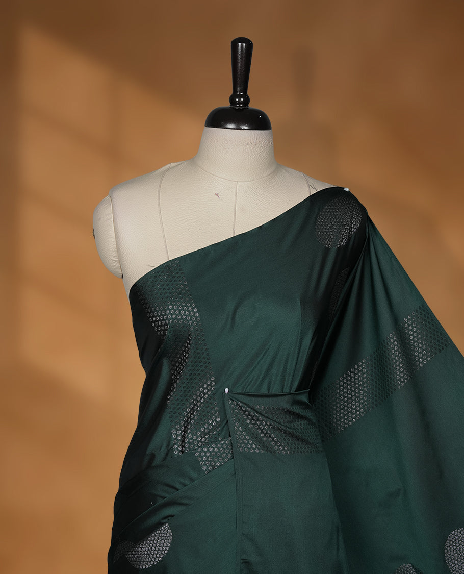 Green colour soft silk saree featuring Antique zari motifs on body with Highlighting contrast Mustard colour pallu and paired with matching blouse piece.