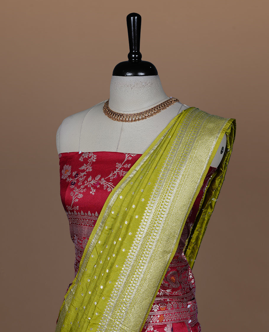 Red colour semi banaras semi stitched dhavani set featuring gold zari floral kodi motifs and traditional border, unstitched matching blouse piece and contrast Olive colour Duptta with silver zari border border.