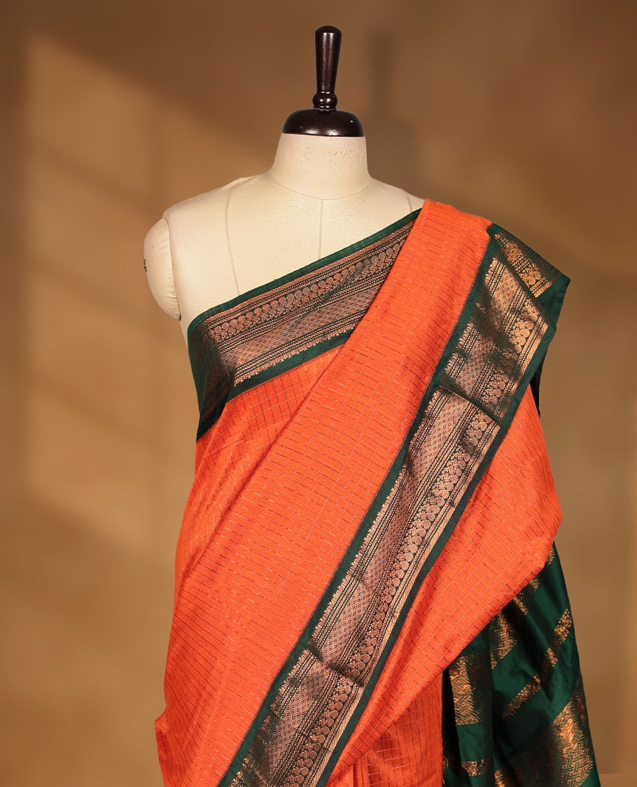 Burnt orange colour kalyani cotton saree featuring Antique zari check pattern on body, contrast Green colour border with antique zari pattern, paired with matching blouse piece.