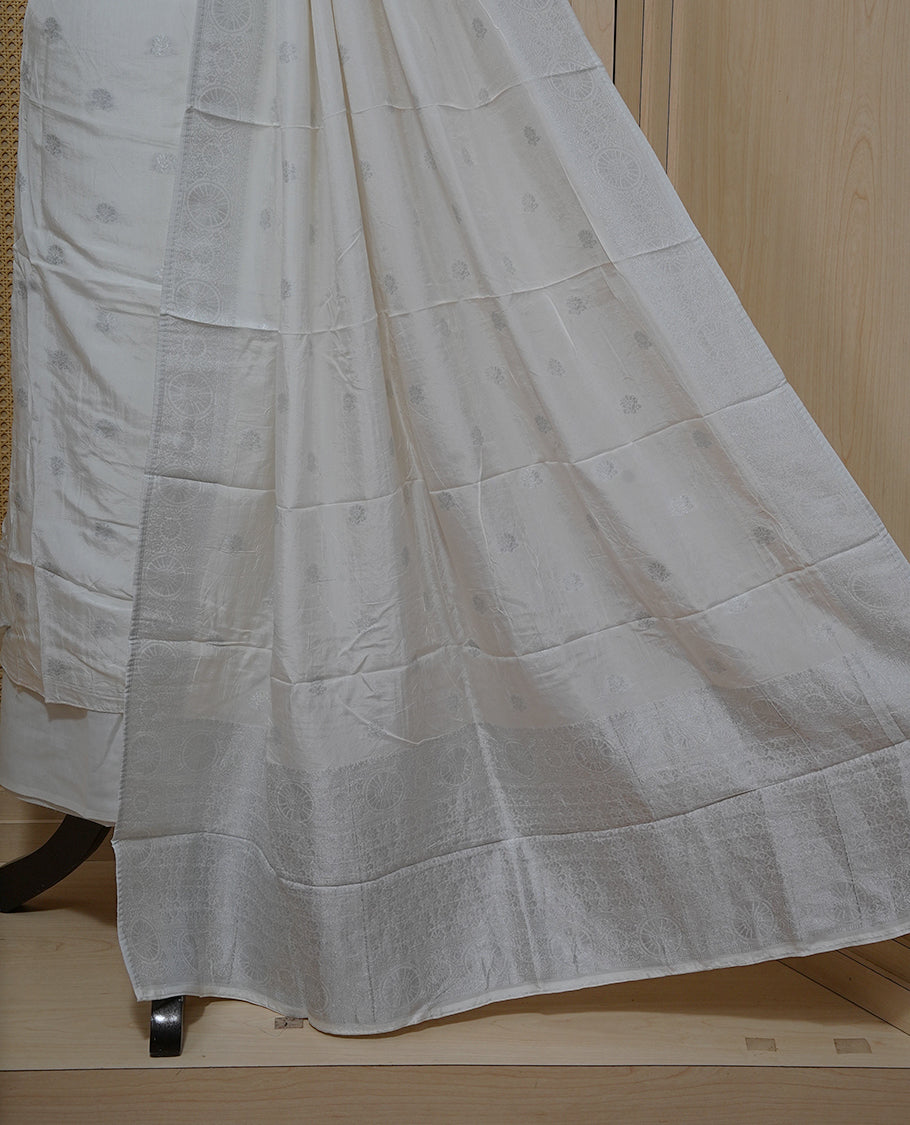 Cream colour Salwar material featuring silver zari Buttas on body & zari worked Neck Portion, paired with matching dupatta & Bottom.