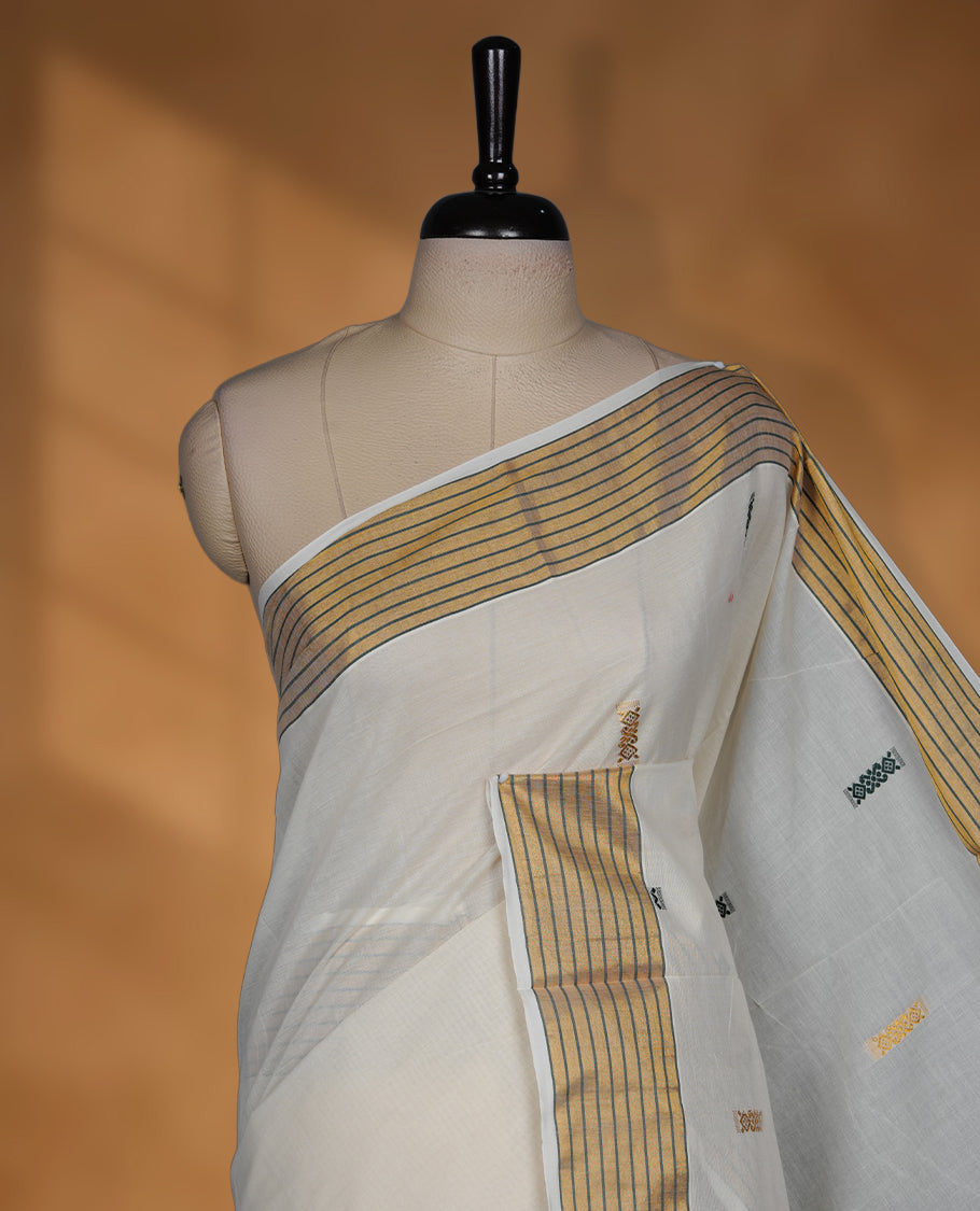 Off white cotton Kerala saree with a plain body and subtle motifs, striped golden zari border, and rich traditional pallu with green accents, paired with a matching blouse.