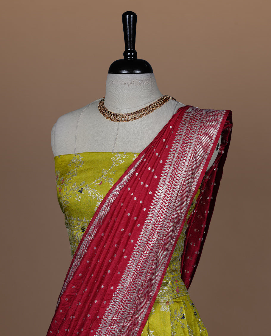 Olive colour semi banaras semi stitched dhavani set featuring silver & multicolour zari motifs and traditional border, unstitched matching blouse piece and contrast red colour Duptta with silver zari border.