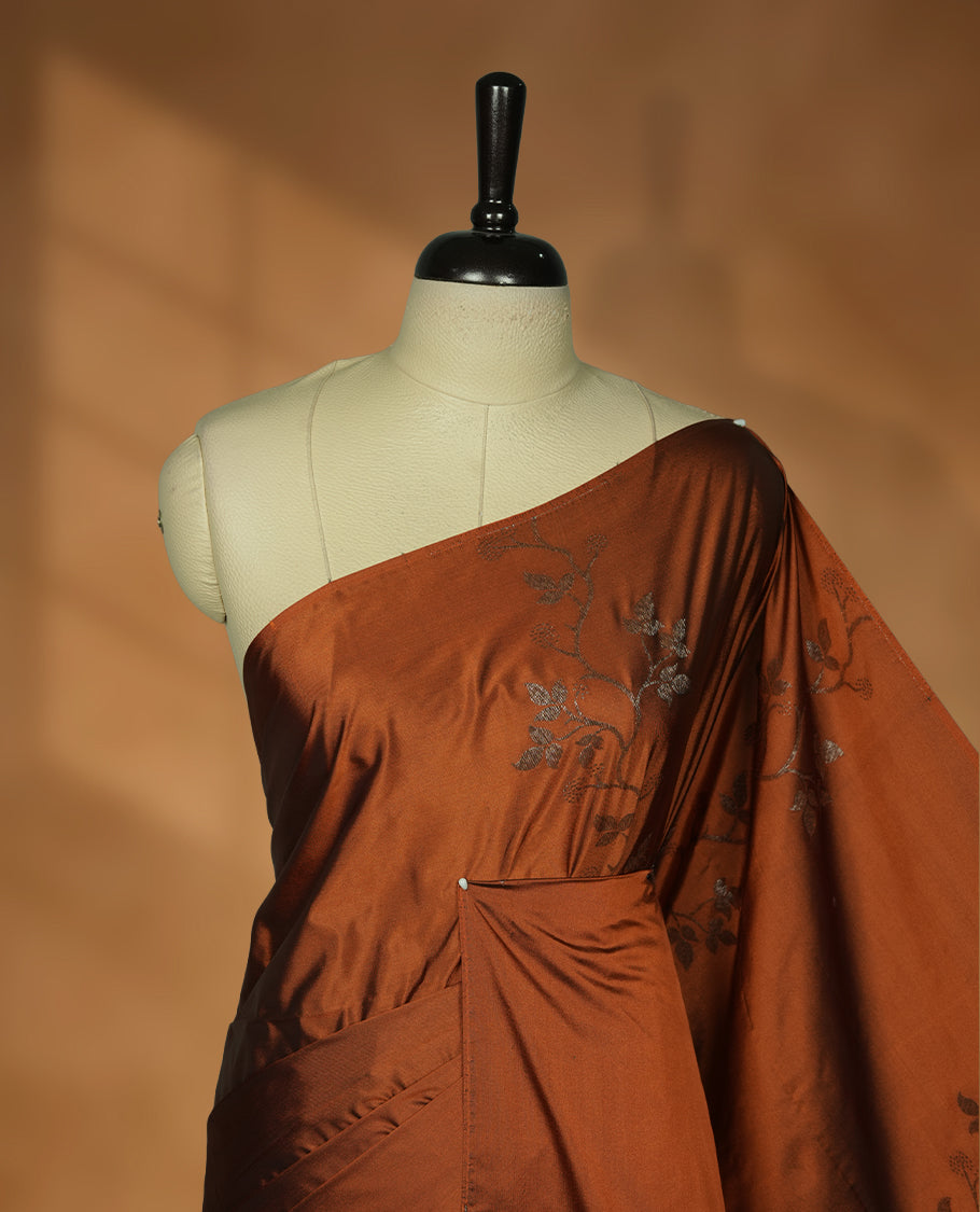Brown colour soft silk saree featuring Antique zari motifs on body with Highlighting contrast green colour pallu and paired with matching blouse piece.