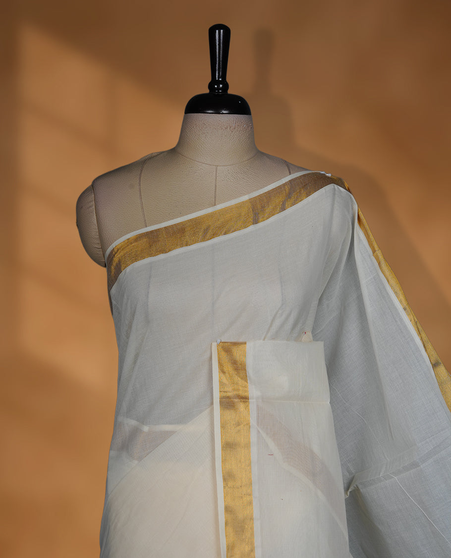 Off white colour cotton Kerala saree featuring a Plain body, an intricately woven traditional border with patterns on pallu, paired with a matching blouse.