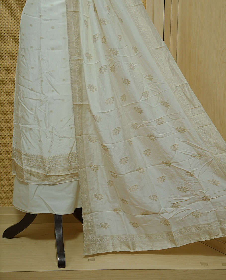 Cream colour Salwar material featuring gold zari Buttas on body, paired with matching dupatta & Bottom.