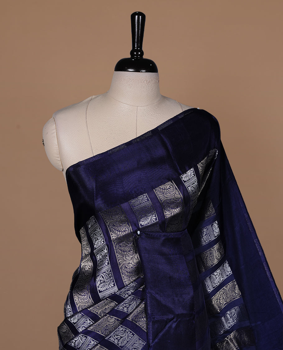 Blue colour banaras crepe saree featuring gold & silver zari design stripes on body, complemented by self colour border, paired with matching blouse piece.