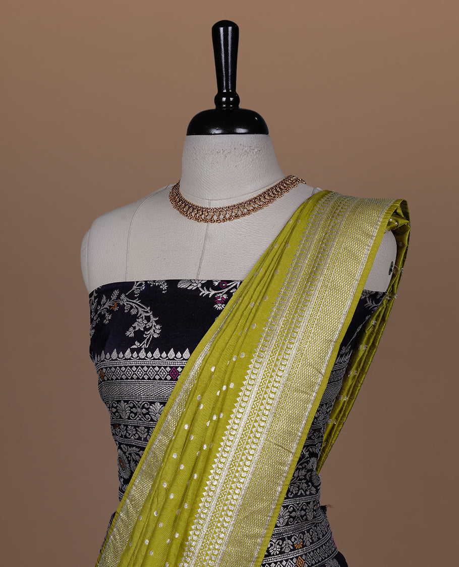 Deep purple colour semi banaras semi stitched dhavani set featuring gold zari floral kodi motifs and traditional border, unstitched matching blouse piece and contrast Olive colour Duptta with gold zari border.