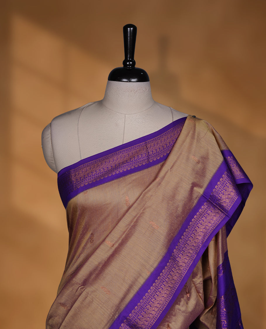 Antique gold colour Kalyani cotton saree featuring a plain elegant body, complemented by a rich Purple zari border and traditional woven pallu, paired with a matching blouse.