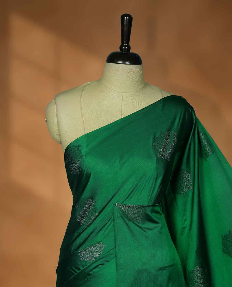 Green colour soft silk saree featuring Antique zari motifs on body with Highlighting contrast Deep Plum colour pallu and paired with matching blouse piece.