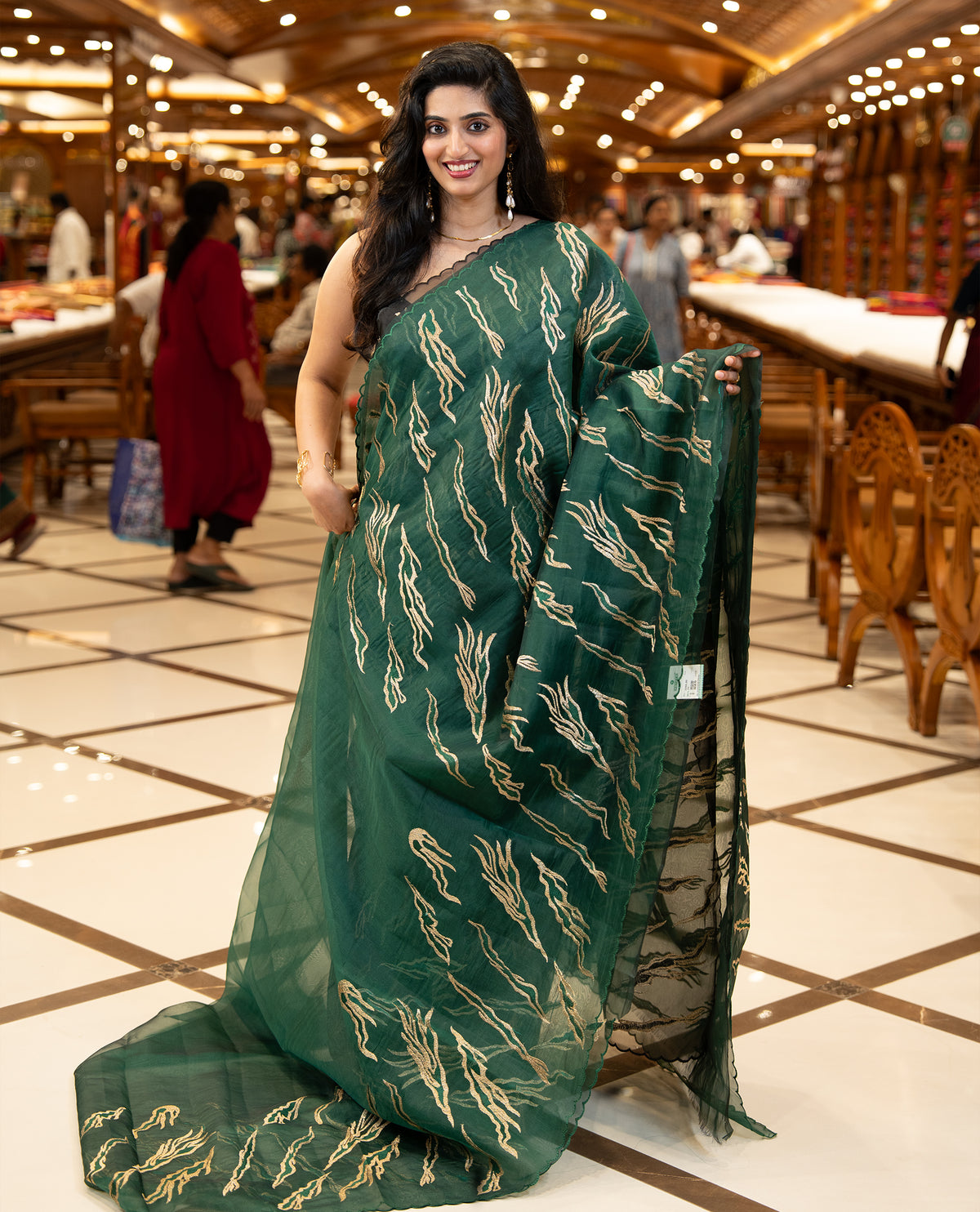 Green colour sheer Organza saree featuring Gold thread embroidery with modern wavy & flame inspired motifs and scallop border, comes with matching organza blouse.
