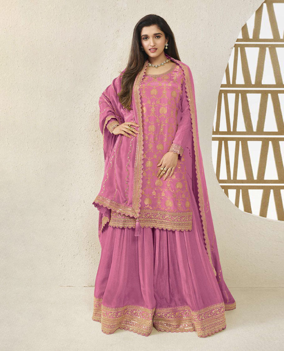 Dusty Pink colour semi stitched salwar suit featuring an embroidered chinon top material paired with a matching sharara bottom, and dupatta.