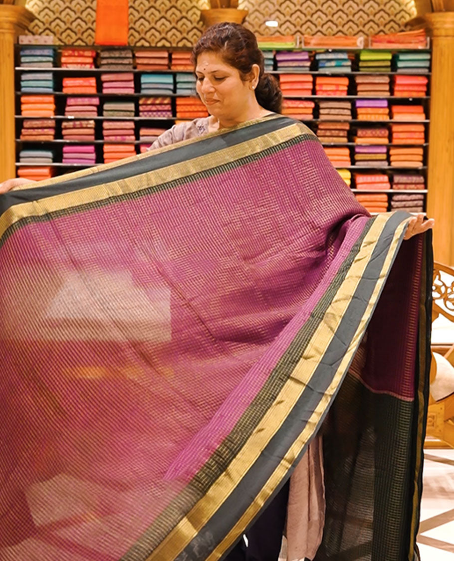 Purple colour moss chiffon saree featuring gold zari checks designed body, complemented by contrast Dark chocolate colour zari jacquard border, paired with contrast colour blouse piece.